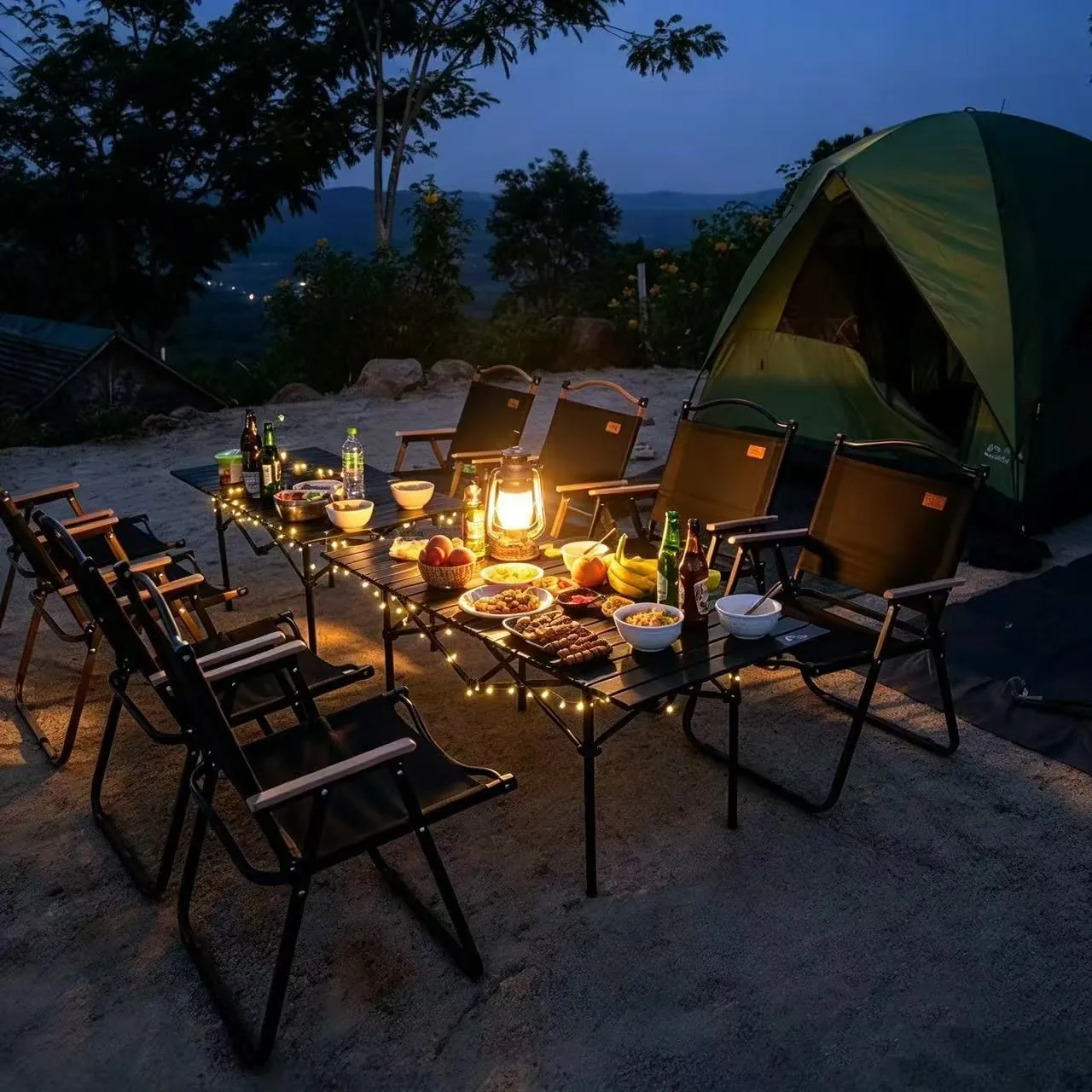 Night camping dinner table with lantern and string lights