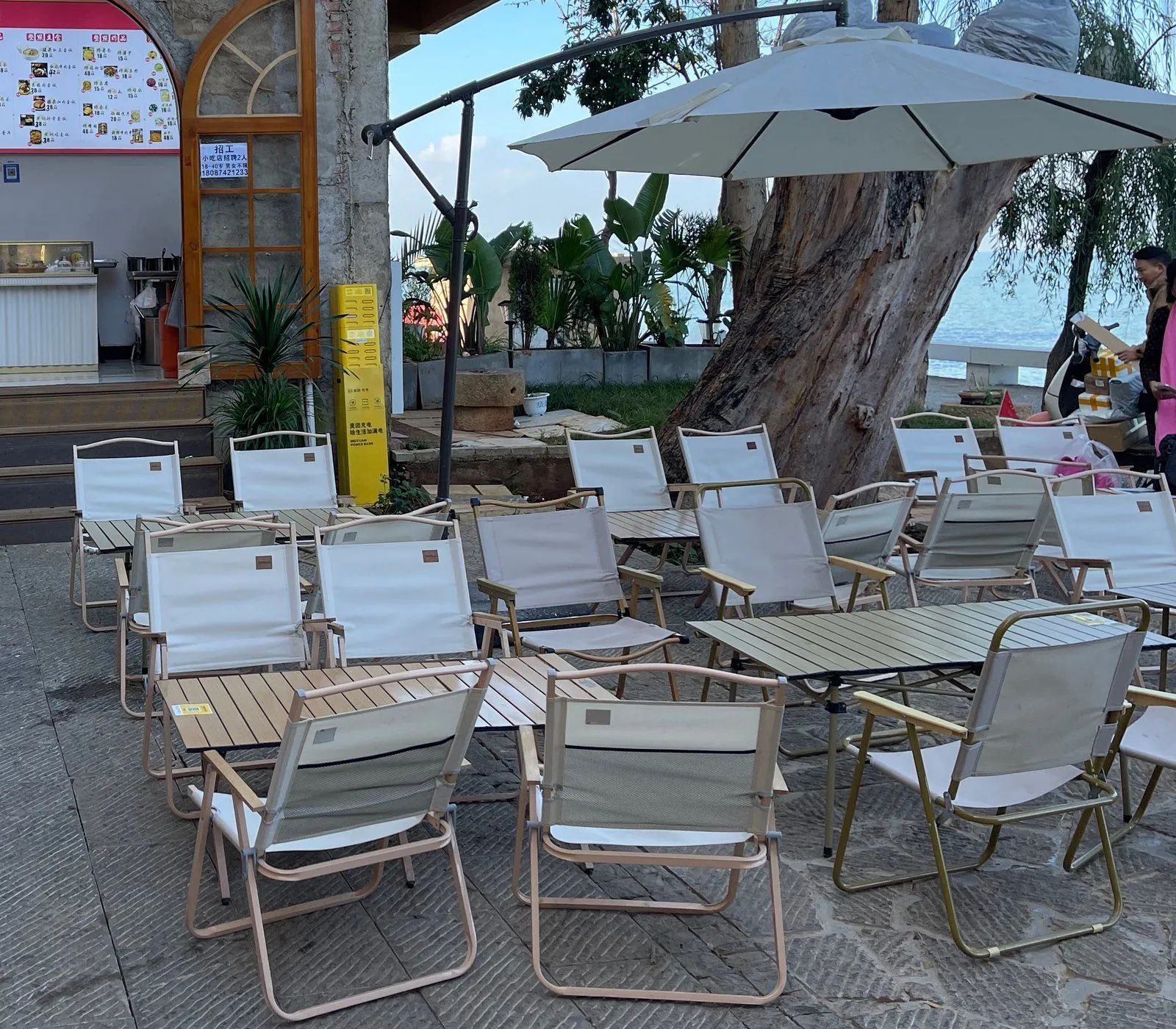 Coastal cafe with white TOPSUN chairs by the sea