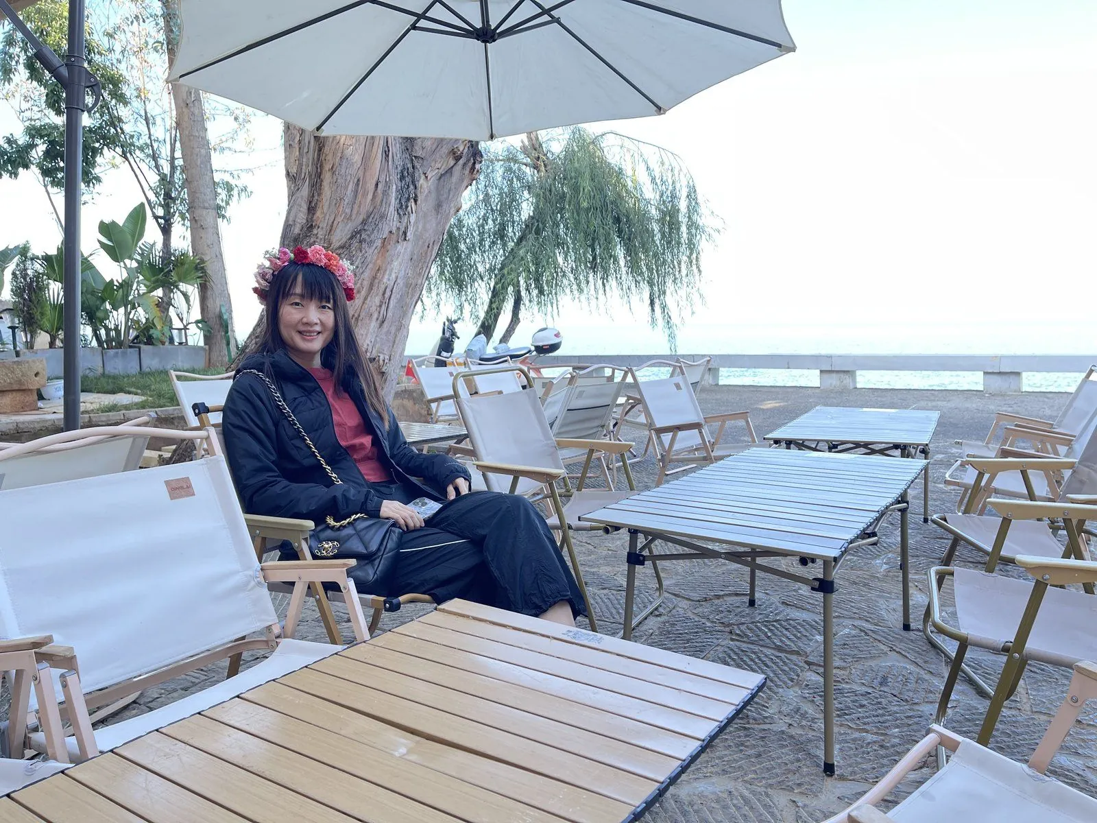 White folding chairs lined up along the shore