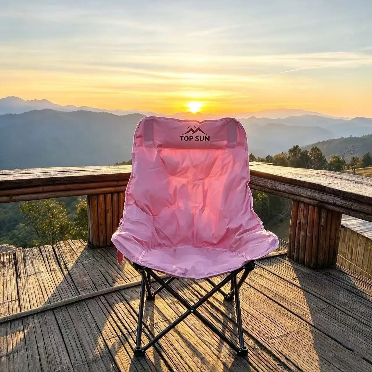 Pink TOPSUN chair on wooden deck at sunset